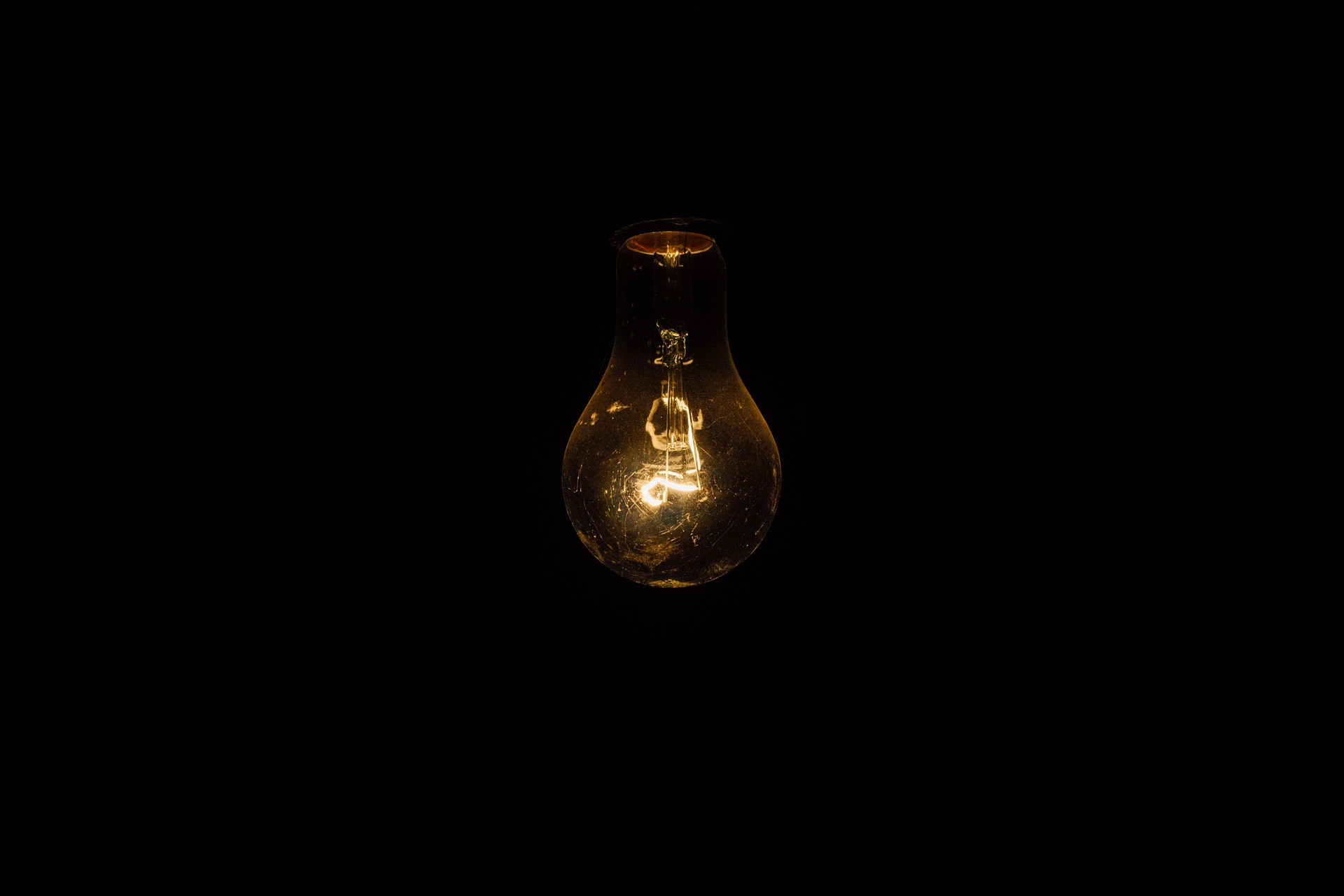 A light bulb with black background.